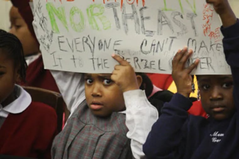 Kids from the Montessori Genesis II School in Mantua hold up a sign during a City Council meeting yesterday.