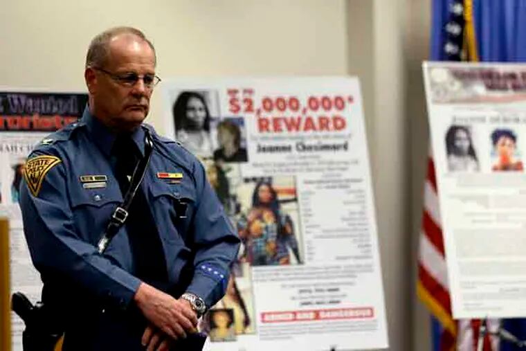 Col. Rick Fuentes, superintendent of the New Jersey State Police, stands next to posters during a news conference giving updates on the search of Joanne Chesimard, a fugitive for more than 30 years, Thursday, May 2, 2013, in Newark, N.J.  The reward for the capture and return of convicted murderer Chesimard, one of New Jersey’s most notorious fugitives, was doubled to $2 million Thursday on the 40th anniversary of the violent confrontation that led to the slaying of a New Jersey state trooper.  The FBI also announced it has made Chesimard, now living in Cuba as Assata Shakur, the first woman on its list of most wanted terrorists.  (AP Photo/Julio Cortez)