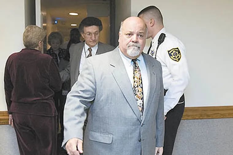 Judge Paul Tressler, leaves through a rear door from the courts chambers at the Montgomery County courthouse, after a 2007 hearing. He's come under scrutiny for hiring his wife as a secretary. (Ed Hille / Staff Photographer)