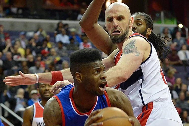 76ers center Nerlens Noel (4) looks to shoots as Washington Wizards center Marcin Gortat (4) defends. (Tommy Gilligan/USA Today)