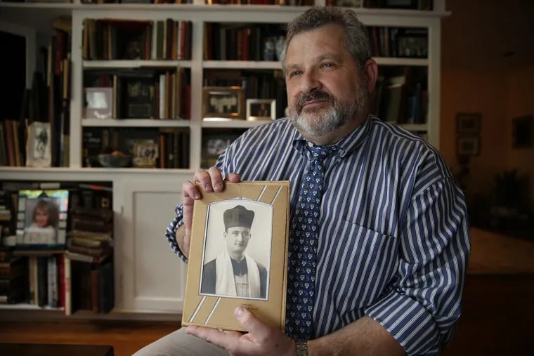 Plastic surgeon Aron D. Wahrman says working with veterans is especially meaningful to him in light of the fact that American soldiers liberated his father (shown in the photo he is holding) from a Nazi prison camp.