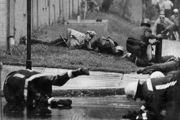 Philadelphia policemen and fireman react as gunfire starts and officers are shot during the August 8, 1978 confrontation with MOVE on Powelton Ave.   Ron Williams / Philadelphia Journal via UPI