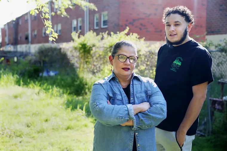 Sylvia Ocasio (left), an assistant program manager at JEVS Human Services, with Wilson Rivera, a former student in JEVS's Project WOW (World of Work), at Ocasio's home in Northeast Philadelphia. Rivera credits Ocasio and the work training program for helping turn around his life.