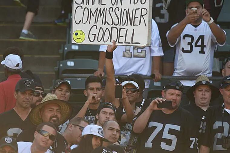 An Oakland Raiders fan holds a sign for NFL commissioner Roger Goodell after the game against the Houston Texans at O.co Coliseum. The Texans defeated the Raiders 30-14. (Kyle Terada/USA Today)