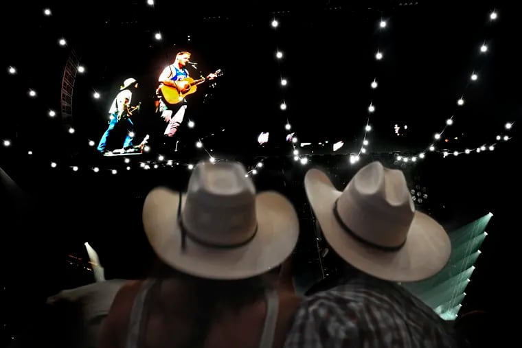 Fans watch on a big screen as country star Zach Bryan performs in the first of two concerts at the Wells Fargo Center Tuesday, May 30, 2023.