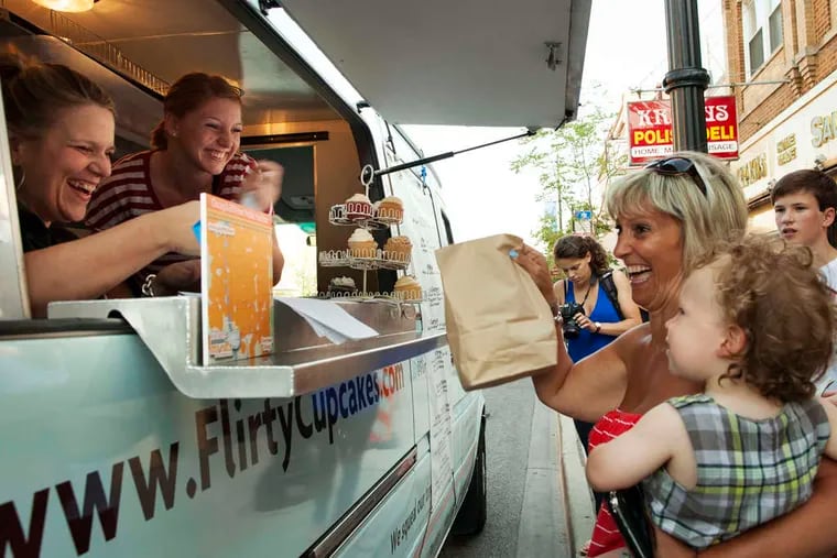 Tiffany Kurtz, owner of the Flirty Cupcakes food truck, sells to customers in Chicago. Kurtz has also opened a bakery in the Windy City called the Flirty Cupcake Dessert Garage. In May the Illinois Supreme Court upheld city regulations aimed to protect restaurants from truck competition.