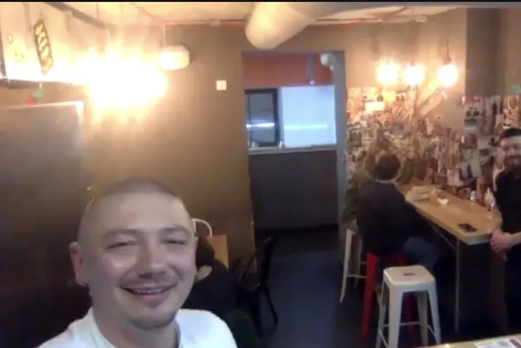 Zhenya Mykhailenko, executive chef and partner in the Kyiv restaurant chain Food vs. Marketing. Despite the Russian attack, he is not closing his ramen restaurant. Pictured here on the first night of the war, he and some of his workers in a restaurant that is also a bomb shelter.