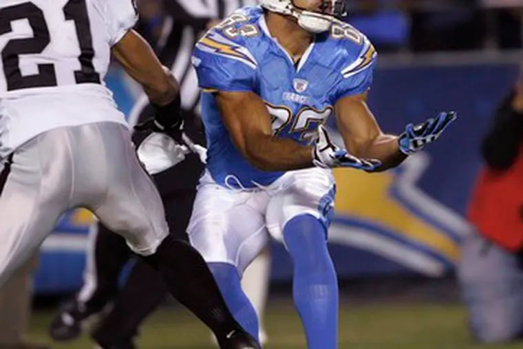 Chargers receiver Vincent Jackson catches a pass in front of Raiders defender Nnamdi Asomugha for a 46-yard gain in the first quarter of last night&#0039;s game. Asomugha was called for interference on the play. San Diego led Oakland, 27-7, at the half. The game ended too late for this edition.