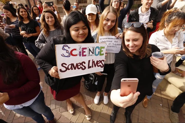 USC Graduate students Mariel Bello, Nina Christie and Alyssa Morris, left to right, pose for a &quot;selfie&quot; to post online and forward to their congressman as USC Graduate students stage a national rally with over 40 other schools to protest the GOP tax bill, which could  significantly boost their taxes. Other changes could come too.