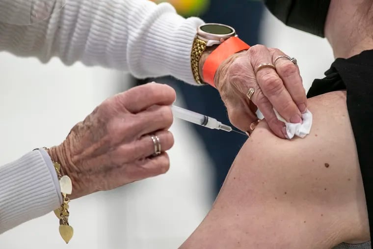 Pat DeHorsey administers a COVID-19 vaccine to a healthcare worker at Montgomery County Community College on Jan. 6.
