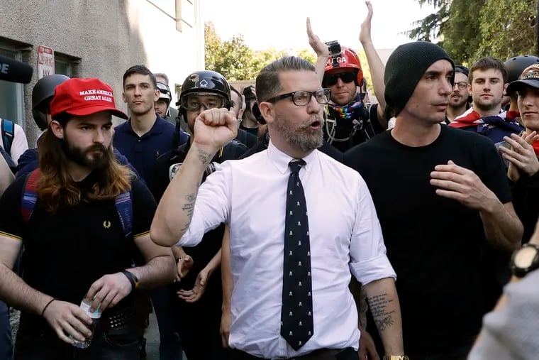 Gavin McInnes, center, founder of the far-right group Proud Boys, is surrounded by supporters after speaking at a rally in Berkeley, Calif. on April 27, 2017.