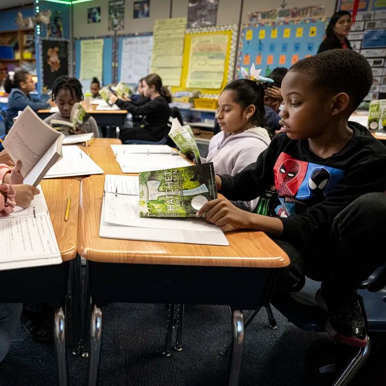 Fourth grade students, Cheyenne Wise, left, and Josiah Forney, read a book on Tuesday, Jan 30, 2024, during a reading class at the Hancock Elementary School in Norristown, Pa.