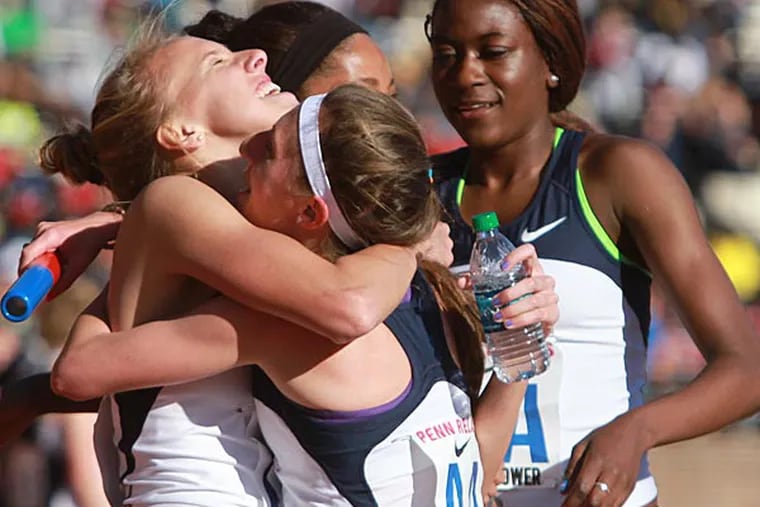 Villanova's Emily Lipari, 2nd from left is hugged by Stephanie Schappert, left, after their victory in the College Women's Distance Medley Championship of America at the Penn Relays on April 24, 2014. Michaela Wilkins is obscurred center and Nicky Akanda is right. (Charles Fox/Staff Photographer)