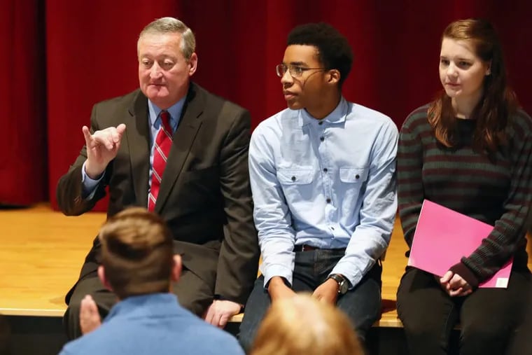 Mayor Jim Kenney sits with Lincoln High students Justice Passe and Megan Davis before a ceremony celebrating the Philadelphia School DistrictÕs improved graduation rate.