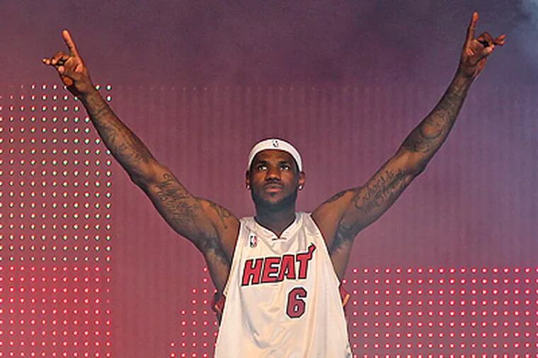 LeBron James enjoys the moment at an event at the American Airlines Arena in Miami. (AP Photo/Miami Herald, Al Diaz)