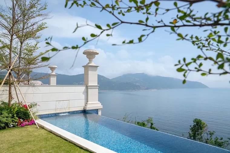 An infinity swimming pool overlooks the South China Sea at a house developed by National Electronics Holdings Ltd. and Baring Private Equity Asia Real Estate in Hong Kong.