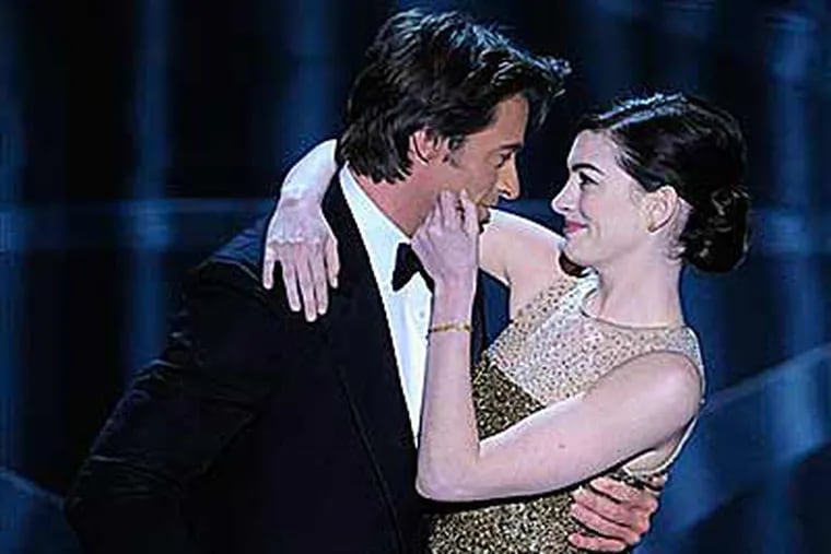 Oscar host Hugh Jackman performs a skit with actress Anne Hathaway during the 81st Academy Awards Sunday. (AP Photo/Mark J. Terrill)