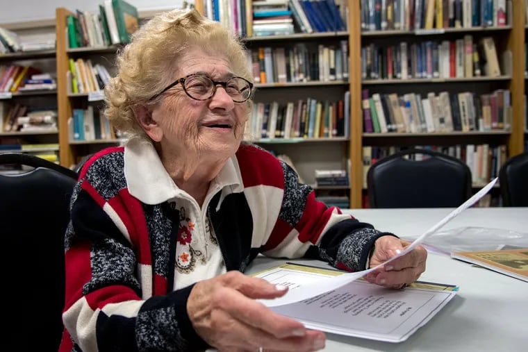 Edith Kutcher, who will soon celebrate her 100th birthday, reads a poem in the library of KleinLife in Northeast Philadelphia.