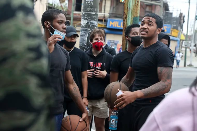 Sam Sessoms, 20, talked with a group of several dozen people who marched down 52nd Street from Haverford to Baltimore Avenue in West Philadelphia on Tuesday June 2. Sessoms is on the basketball team at Penn State.