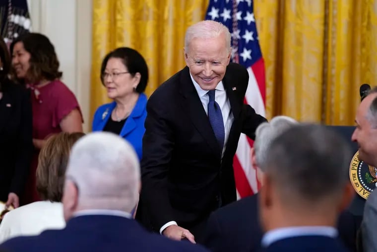 President Joe Biden talks with House Speaker Nancy Pelosi of Calif., after signing the COVID-19 Hate Crimes Act, in the East Room of the White House.