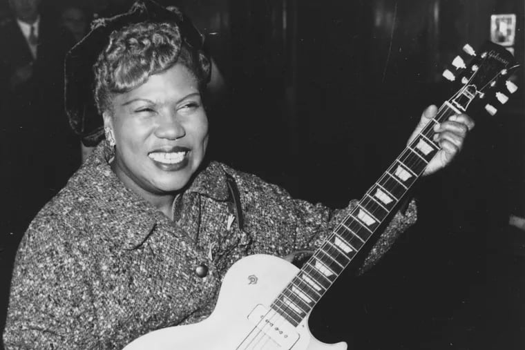 Sister Rosetta Tharpe, guitar-playing American gospel singer, gives an inpromptu performance in a lounge at London Airport, following her arrival from New York on November 21, 1957.