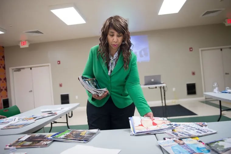 Marrea Walker-Smith, of CEO Academy, passes out materials for creating vision boards during a personal development seminar at Booker T. Washington Community Center in Chester.