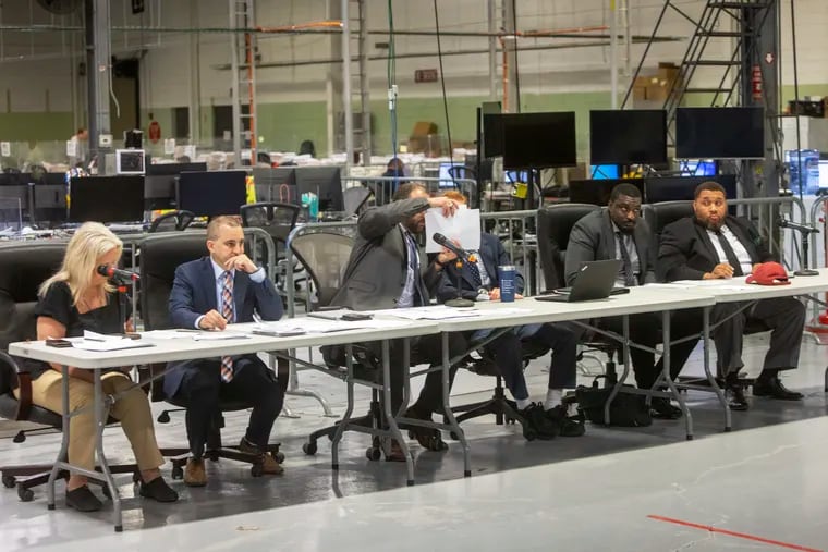 Philadelphia elections officials on Friday at their warehouse in Northeast Philadelphia, where they were voting on whether to count or reject certain provisional ballots in the Pennsylvania Republican Senate primary.