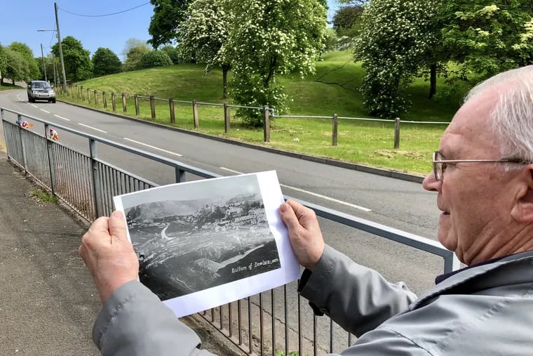 Eric Thomas, columnist Kevin Riordan's cousin, compares a present-day view of a main road into Dowlais, in South Wales, UK, with a photograph of the area during its industrial heyday.