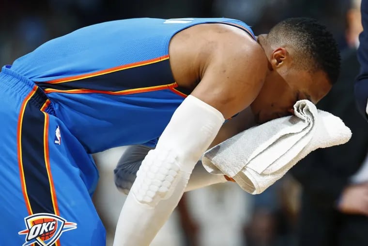 Oklahoma City Thunder guard Russell Westbrook holds a towel to his head during a time out after he was hit in the face by Denver Nuggets center Nikola Jokic, of Serbia, in the first half of an NBA basketball game Thursday, Nov. 9, 2017. (AP Photo/David Zalubowski)