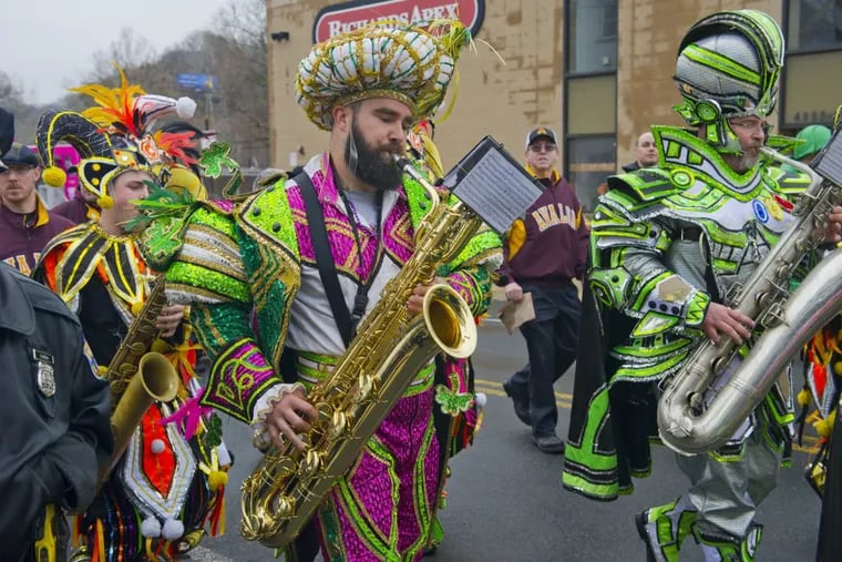 Eagles center Jason Kelce plays his saxophone with the Avalon String Band during the 5th Annual Mummers Mardi Gras Parade Sunday in Manayunk. Avi Steinhardt / For the Philadelphia Inquirer