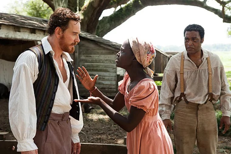 Michael Fassbender, left, Lupita Nyong'o and Chiwetel Ejiofor, right, in a scene from "12 Years A Slave." (AP Photo/Fox Searchlight, Francois Duhamel)