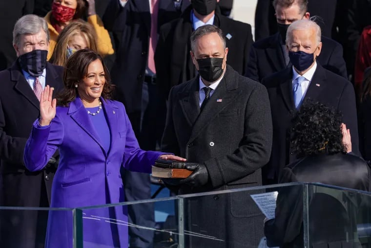Vice President Kamala Harris is sworn into office as her husband, Doug Emhoff, watches on the West Front of the U.S. Capitol.
