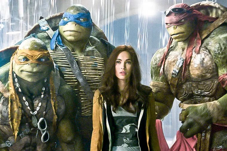 This image released by Paramount Pictures shows, from left, Michelangelo, Leonardo, Megan Fox, as April O'Neil, Raphael, and Donatello in a scene from "Teenage Mutant Ninja Turtles." (AP Photo/Paramount Pictures, Industrial Light & Magic)