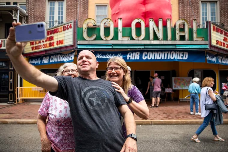 Blobfest revelers Mike and Rebecca Dauber, of Douglassville, Berks County, take a selfie with Della Dry (left), of Birdsboro, Pa., in front of the historic Colonial Theatre in Phoenixville.