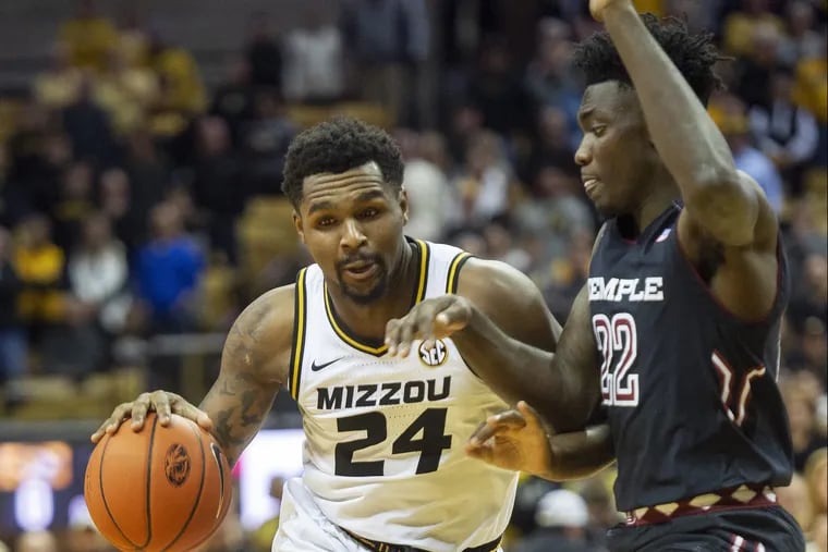 Missouri's Kevin Puryear, left, dribbles past Temple's De'Vondre Perry during the first half of an NCAA college basketball game Tuesday, Nov. 27, 2018, in Columbia, Mo. (AP Photo/L.G. Patterson)