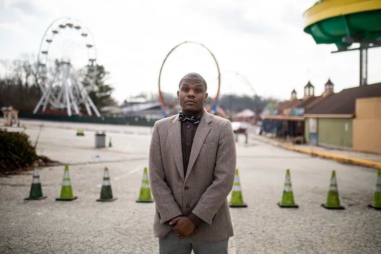 Melvin Brown Jr., 31, of Sicklerville, a leader of Fresh Development LLC, in front of Clementon Park and Splash World. Brown hopes to purchase the property in a auction with the goal to keep the amusement park and make into a resort.
