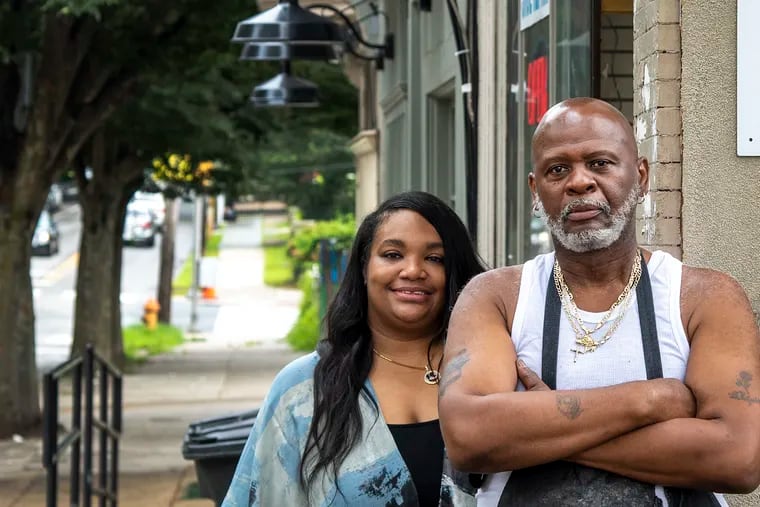 Shani Newton and Willie Alston outside Ace Shoe Repair in Mount Airy. Newton, owner of Dolly's Boutique, posted a plea to customers to support Ace Shoe Repair, a business up the street. And customers responded.
