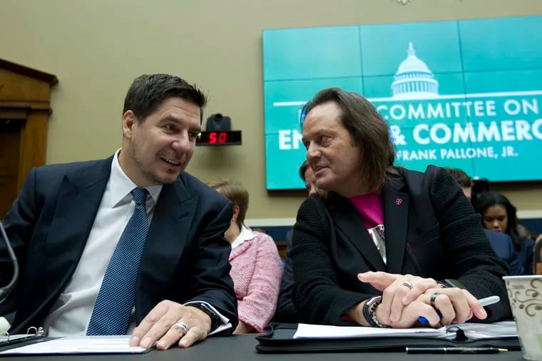 Sprint Corporation Executive Chairman Marcelo Claure, left, speaks with T-Mobile US CEO and President John Legere during the House Commerce subcommittee hearing on Capitol Hill in February 2019.