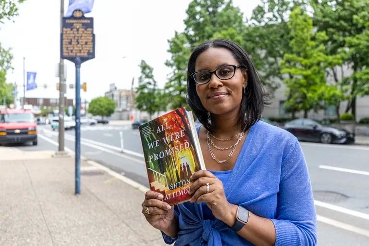 Ashton Lattimore, author of “All We Were Promised," in front of the historical marker at Sixth and Race Streets where Pennsylvania Hall once stood.