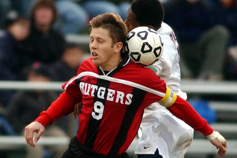 Rutgers' Dennis Ludwig (9) heading the ball away from Connecticut's Damani Ralph during a second-round NCAA Tournament game in November 2001. Ludwig scored both goals in Rutgers' 2-1 win.