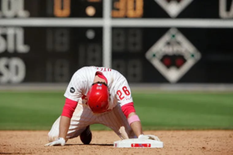 Second thought: The Phillies Chase Utley hangs his head as he kneels at second base after being tagged for the final out of a 4-1 loss to the Cubs while trying to stretch a single into a double.