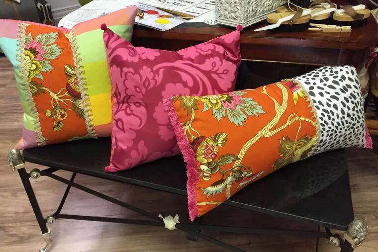 Pillows, above, and an apron, left, from Home on Haddon, among merchants and retailers participating this weekend in Haddonfield's August sidewalk sale, a kind of &quot;outdoor bazaar.&quot;