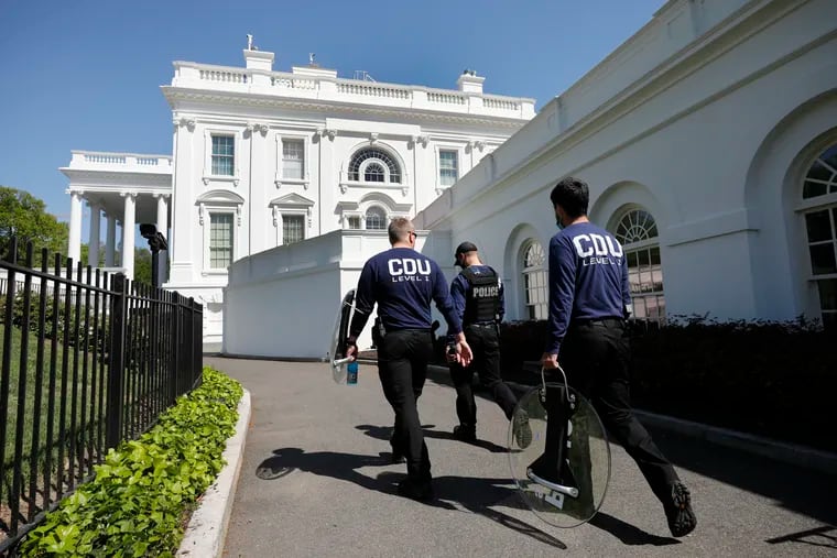 Members of U.S. Secret Service, shown carrying riot shields on a driveway at the White House on April 20, 2021.