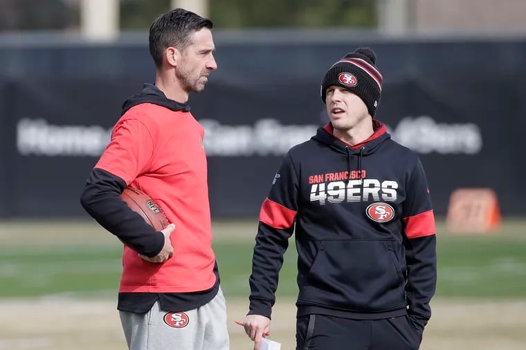 Passing-game coordinator Mike LaFleur (right) talking to head coach Kyle Shanahan at a practice last week.