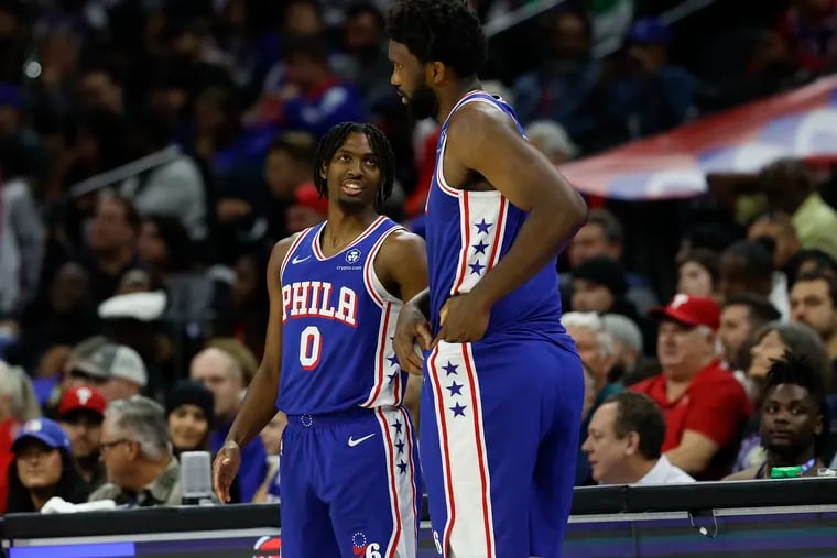 Sixers guard Tyrese Maxey with teammate center Joel Embiid against the Washington Wizards on Nov. 6.