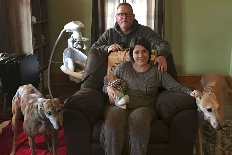 Nessie (far left), reunited with her family, Crystal and Shawn Munion, baby Dylan, and greyhound Bobby.