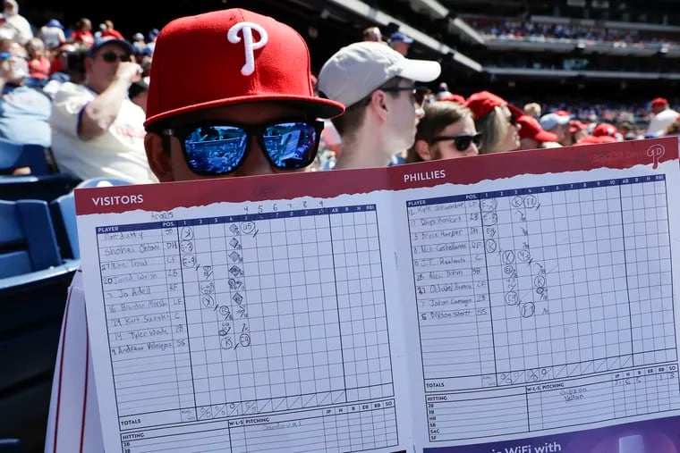 Caleb Leader holds his scorecard while the Phillies played the Los Angeles Angels on June 5, 2022 in Philadelphia.