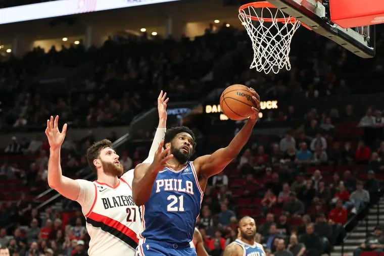 Joel Embiid drives to the basket on the Blazers' Jusuf Nurkic. The Sixers center finished with 32 points.