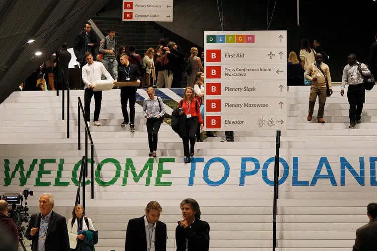 People walks down the stairs inside the venue of the COP24 U.N. Climate Change Conference 2018 in Katowice, Poland, Tuesday, Dec. 4, 2018. The two-week meeting brings together diplomats and interested pressure groups from almost 200 countries to discuss the 2015 Paris Accord and other climate issues. (AP Photo/Czarek Sokolowski)