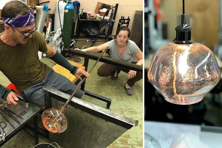 At Remark Glass in South Philadelphia, Mark Ellis and Rebecca Davies craft a light fixture out of a wine bottle. Remark is one of several local companies doing the work on aether restaurant in Fishtown.